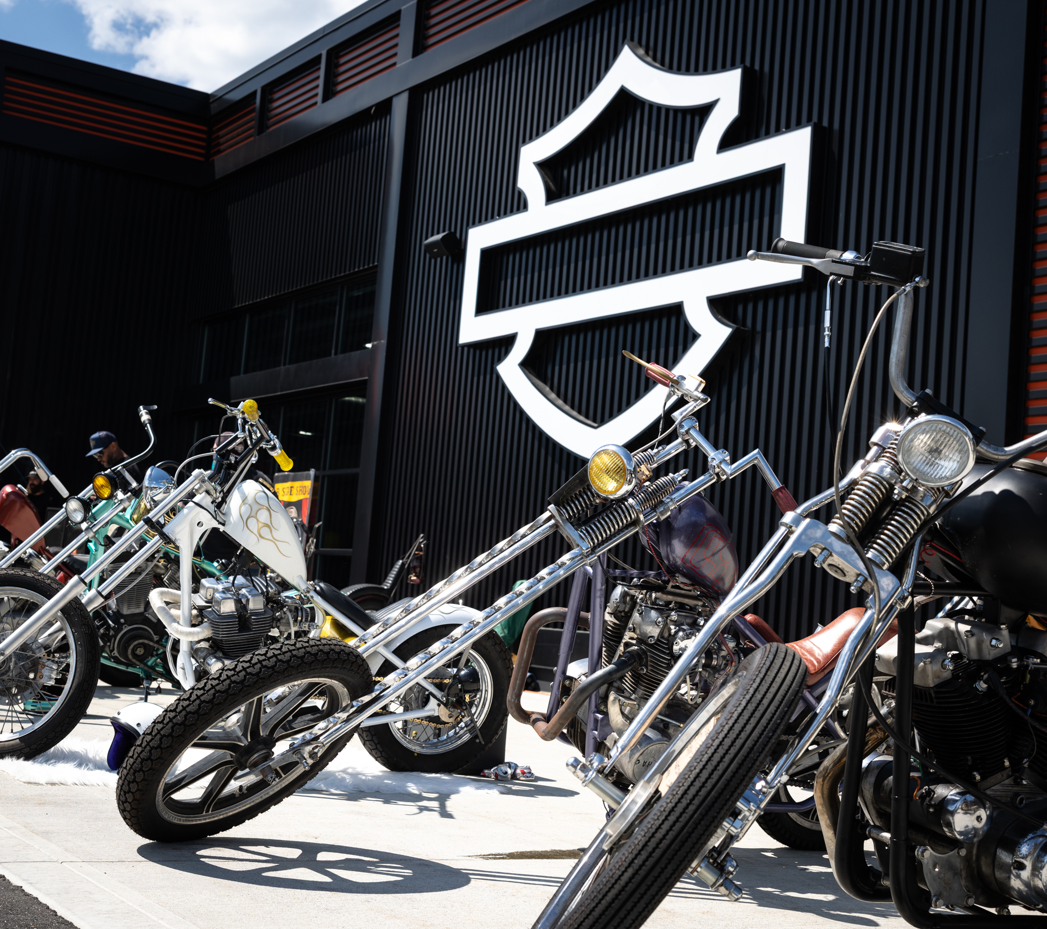Row of custom choppers lined up outside Manchester Harley-Davidson at the Idle Hands Chopper Show