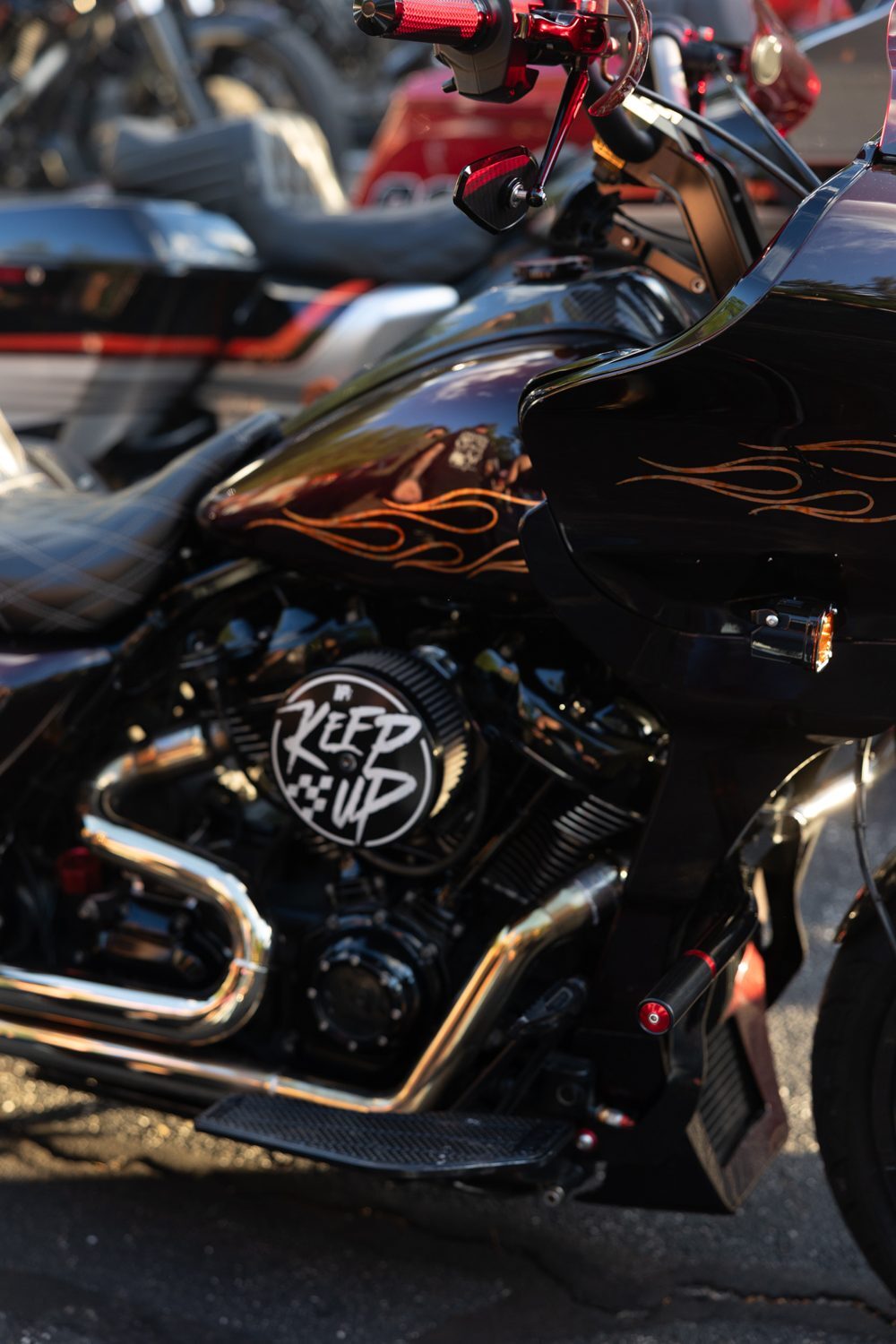 Black bagger with flame paint and chrome exhaust at the Proper Baggers show