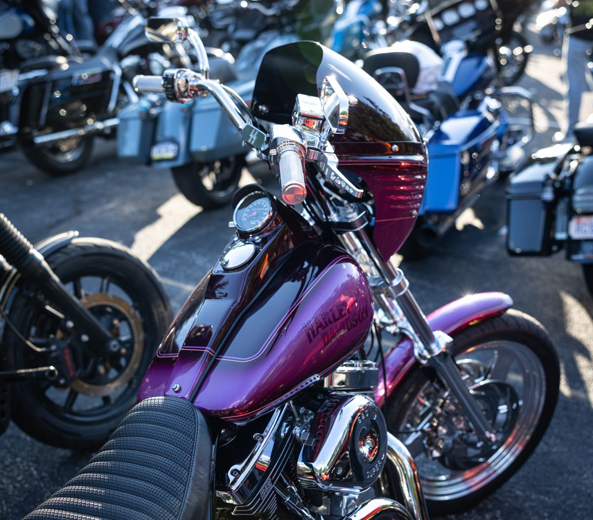 Magenta custom Harley with chrome front end at the Proper Baggers show