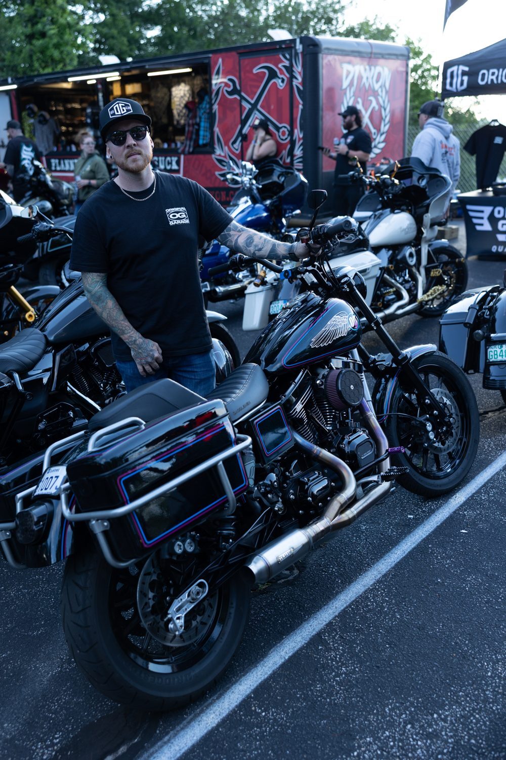 Builder standing with his custom Harley at the Proper Baggers show