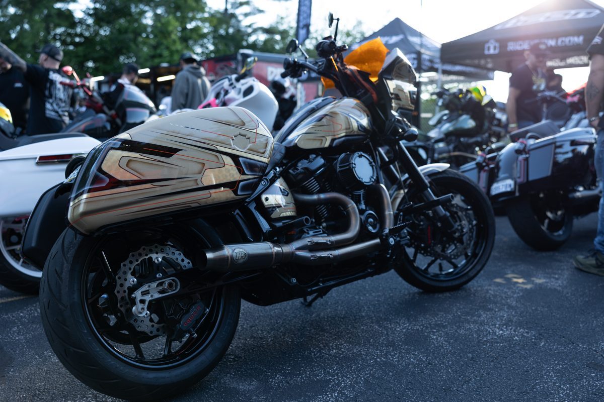 Gold and white performance bagger with custom exhaust at Laconia Harley-Davidson